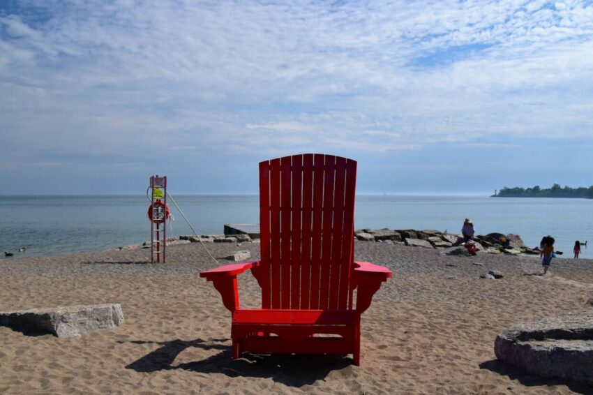 red wooden armchair on beach shore during daytime